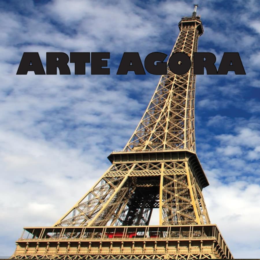 Image of the Eiffel Tower from below with blue sky and clouds